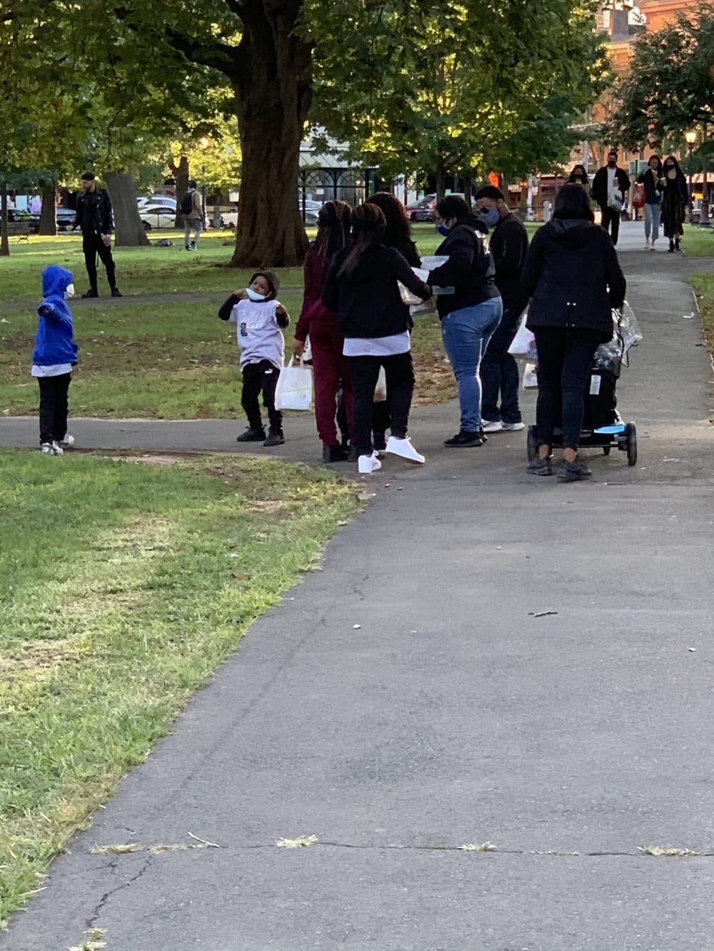 Volunteers handing out care packages in a city park