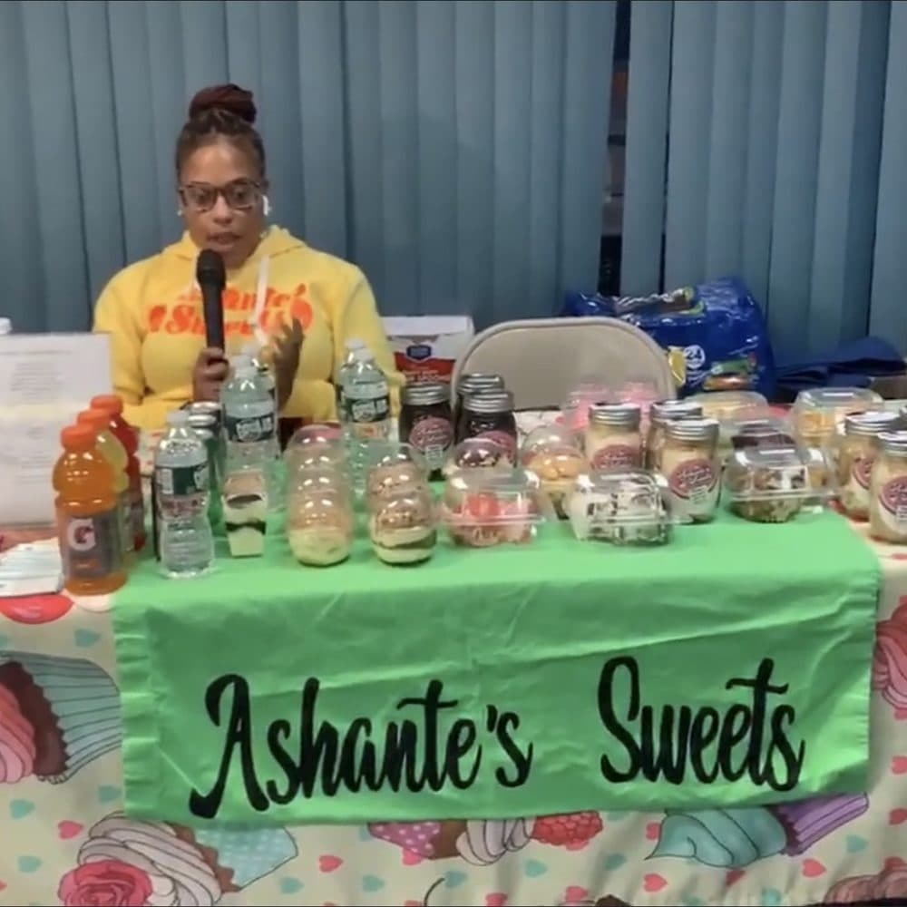 A small business owner presenting her products at the Latter Rain Marketplace