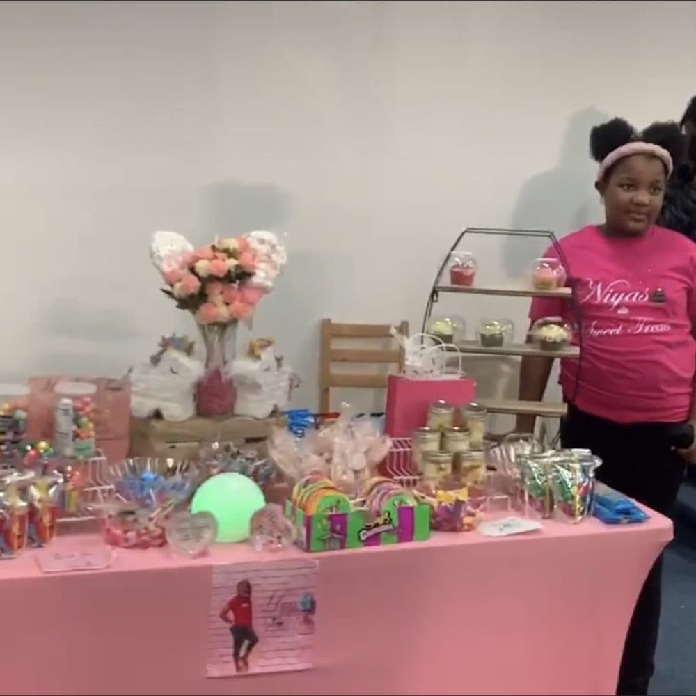 A young entrepreneur at her sweets table during the Latter Rain Marketplace