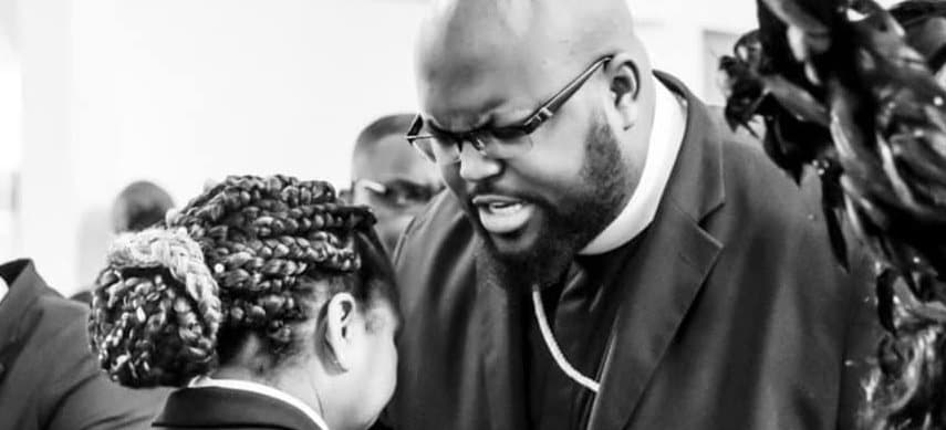 Pastor Charles welcoming a guest