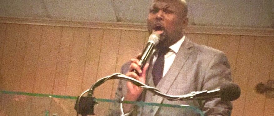 Pastor Charles preaching